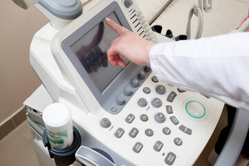 The doctor using the ultrasonography device, close view
