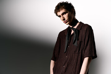 Obraz premium Handsome young man showcases stylish attire with confidence in a modern setting