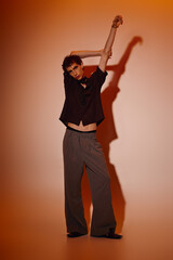 Stylish young man showcasing modern fashion in a creative studio setting