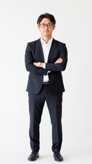 A man in a black suit stands with arms crossed, showcasing a confident demeanor in a minimalistic setting, emphasizing professionalism