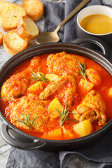 Chicken Bouillabaisse with Rouille and bread closeup in the plate on the table. Vertical
