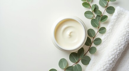 White bowl of cream next to a white towel