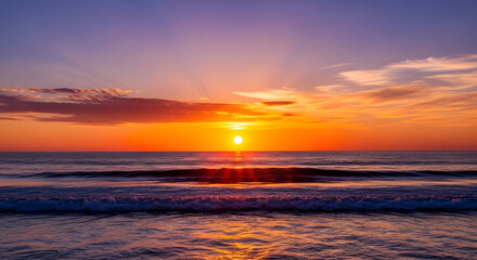 Fototapeta premium Ocean Sunset: A breathtaking ocean sunset paints the sky with fiery hues of orange and gold, casting a serene glow over the tranquil water. 
