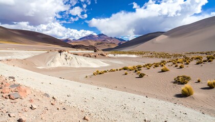 A vast, arid landscape with hills and low, scrubby vegetation under a partly cloudy sky
