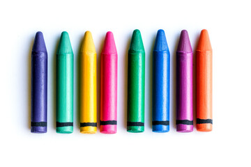 Ten vibrant crayons in various colors are neatly aligned on a plain background, showcasing their cheerful hues and simple design