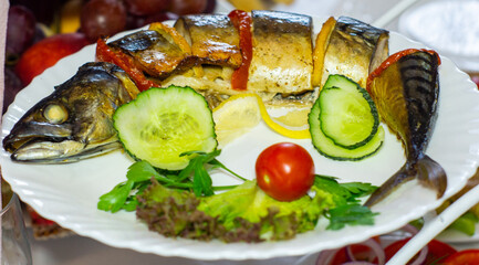 Freshly grilled fish served with vegetables and garnishes at a festive banquet