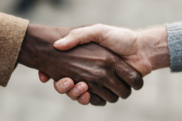 Fototapeta premium Business Negotiation Moment Two Businesspeople Shaking Hands in Urban Environment Documentary Style Photo
