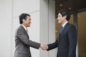 Business Deal Between Two Japanese Businessmen Urban Setting Documentary Style Photo Professional Environment Close-Up View