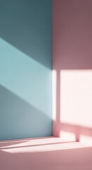 A corner of a room with walls painted in pastel blue and pink, with sunlight creating shadows.