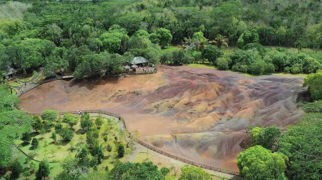 Aerial view of the undulating, colorful dunes of the Seven Colored Earth Geopark, a geological wonder surrounded by lush greenery, Chamarel, Rivi&egrave;re Noire District, Mauritius.