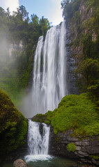 Fototapeta premium Waterfall in nature. Majestic waterfall with mist. Beautiful flowing water landscape.