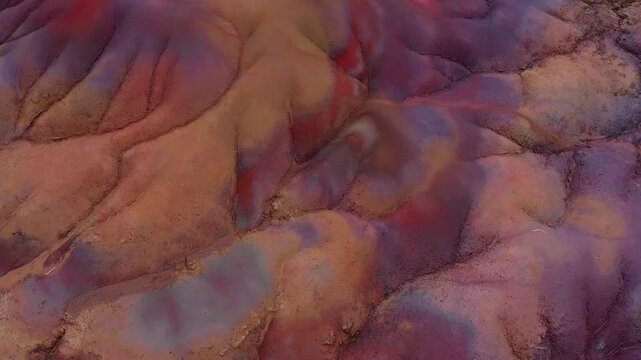Aerial view of the undulating terrain of the Seven Colored Earth Geopark, a canvas painted with hues of red, brown, violet, and ochre, Chamarel, Rivi&egrave;re Noire District, Mauritius.