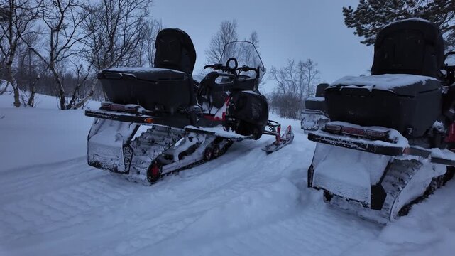 Parked snowmobiles on rural countryside road in the winter.