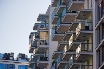 Glass balconies in multi-family buildings, apartment density, real estate, and housing market.