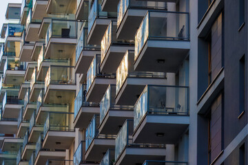 Glass balconies in multi-family buildings, apartment density, real estate, and housing market.