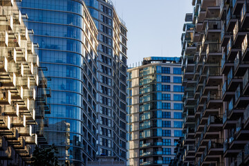 Glass balconies in multi-family buildings, apartment density, real estate, and housing market.