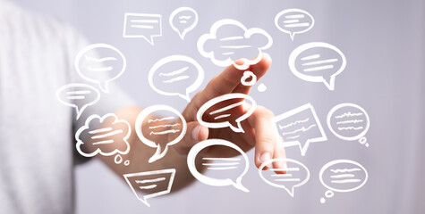 Image of hand interacting with digital speech bubbles, representing communication, dialogue, and social media.