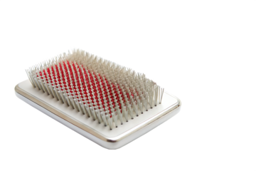 Pet grooming brush with red and white bristles isolated on a transparent background