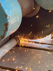 Close-up of metal cutting with industrial circular saw, creating sparks – a powerful depiction of fabrication, construction work, and industrial safety operations.