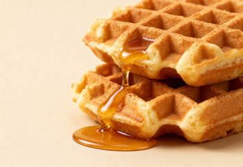 Golden waffles drizzled with syrup.