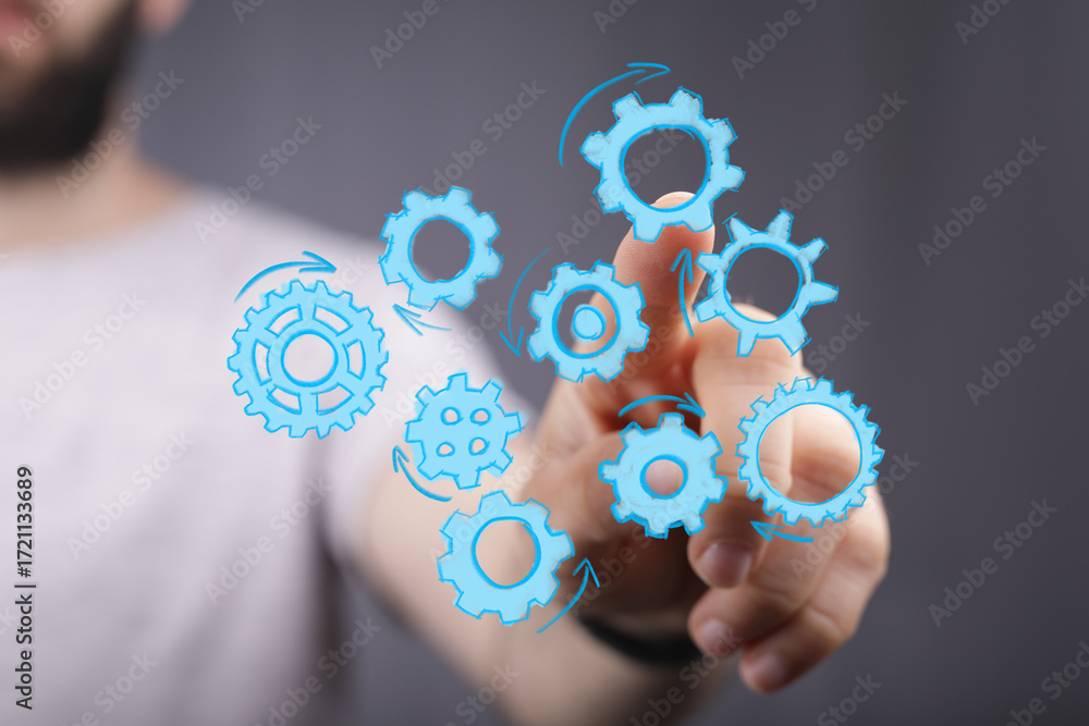 Poster image of hand interacting with digital gears, symbolizing teamwork, efficiency, and workflow solutio
