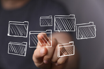 Person interacts with digital files, selecting data.  Concept of organization, data management, and technology.