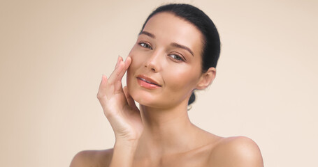 Moisturized Skin Care Concept with Woman Touching Face on Beige Background