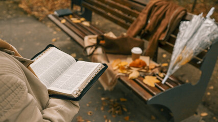 Reading the Bible in an Autumn Park