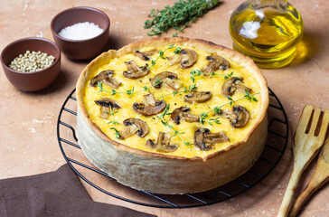 Quiche or open pie with mushrooms, cheese, and thyme. French cuisine. Vegetarian food.