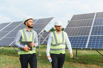 Engineers inspecting solar power panels on site