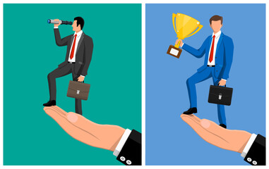Man standing high on hand, looking through telescope and man with trophy. Business opportunity and victory concept.