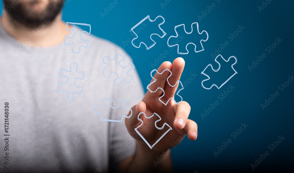 Poster abstract image of a hand connecting puzzle pieces. represents problem solving, strategy, teamwork, a