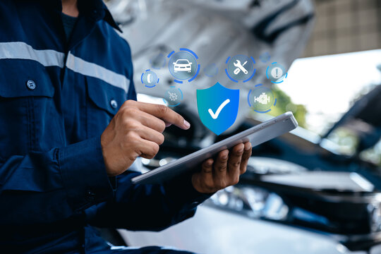 Mechanic using tablet with shield with the auto,Customer care.