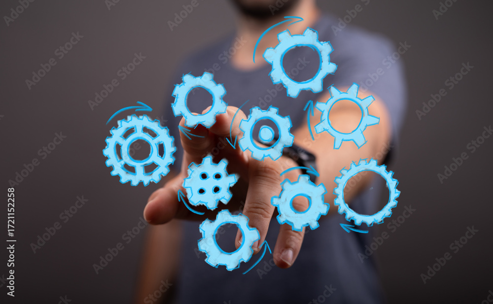 Poster abstract image of a man interacting with digital gears, symbolizing teamwork, process, and collabora
