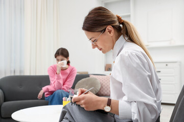 Obraz premium Professional psychologist working with teenage girl in office, selective focus