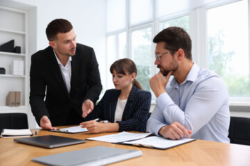 Couple having meeting with business consultant at table in office