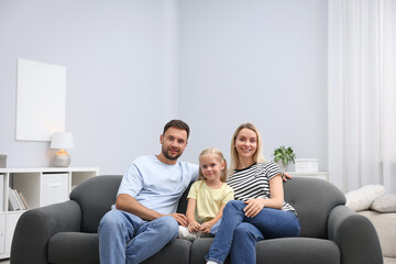 Happy family spending time together on sofa at home