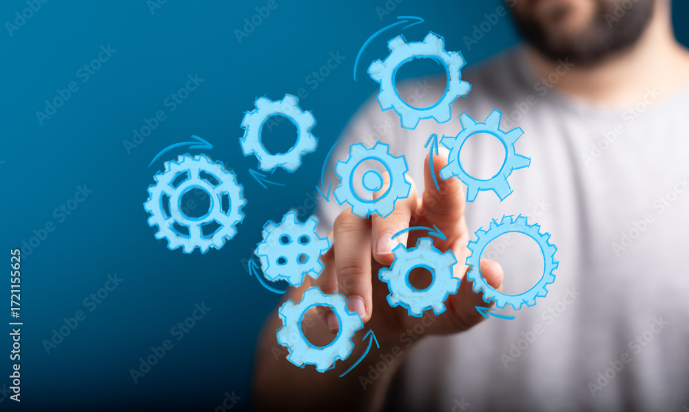 Poster abstract image of a hand interacting with digital gears, symbolizing teamwork, process, and workflow