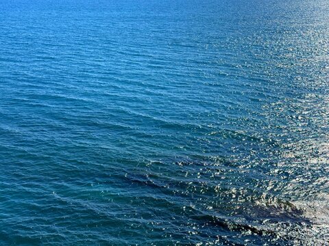 Blue glittering ocean water surface.