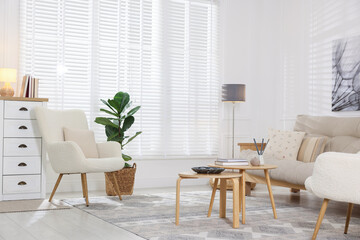 Stylish living room with lamp, houseplant and sofa. Interior design