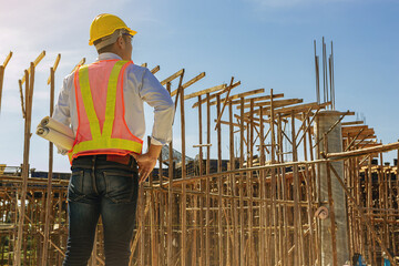Smart civil architect engineer inspecting and working, command at outdoors building side with blueprints. Engineering and architecture concept