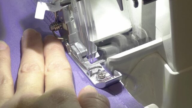 Mastering sewing techniques with a serger machine in a cozy workshop setting