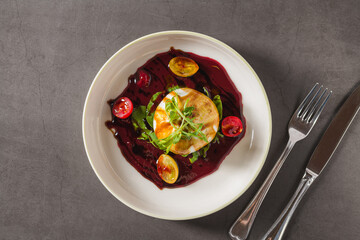 Creamy burrata cheese with beet sauce, arugula and cherry tomatoes