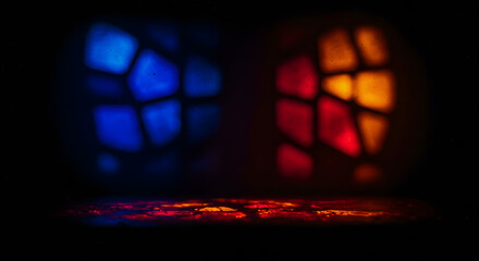 An atmospheric abstract photo of colorful stained glass light projected onto a dark surface, with an intentional soft blur to create a moody, mysterious, or spiritual background.