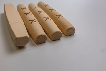 The Yut pieces from the traditional Korean game Yut Nori are neatly arranged on a white background. Close-up.