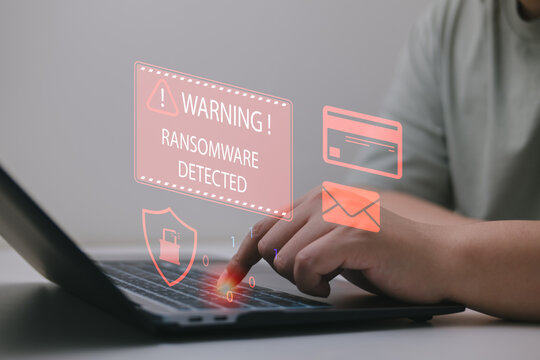 Proactive ransomware defense concept with alert message and icons on screen, user typing on laptop, related to phishing attack, email threats, data breach, and cybersecurity protection.