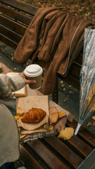 Autumn picnic with coffee and croissant