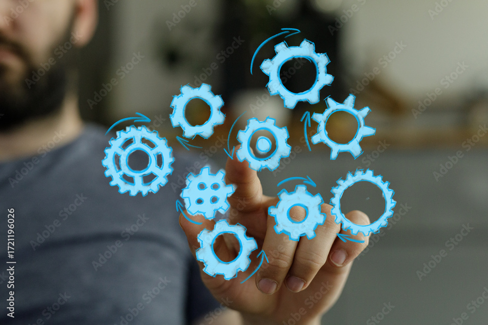 Poster abstract image of a man interacting with digital gears, symbolizing teamwork, process, and innovatio