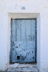 Colorful facade with Blue door with peeling paint