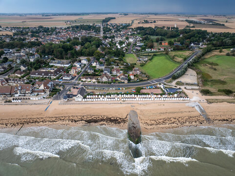 Aerial view of the beach lined with beach huts where the sand meets the waves, Berni&Atilde;&uml;res-sur-Mer, Normandy, France.